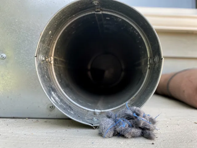 Tega Cay Dryer Vent Cleaning technician using specialized equipment to clear severe dryer vent blockage in Tega Cay